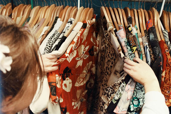 Woman browsing vintage Hawaiian shirts