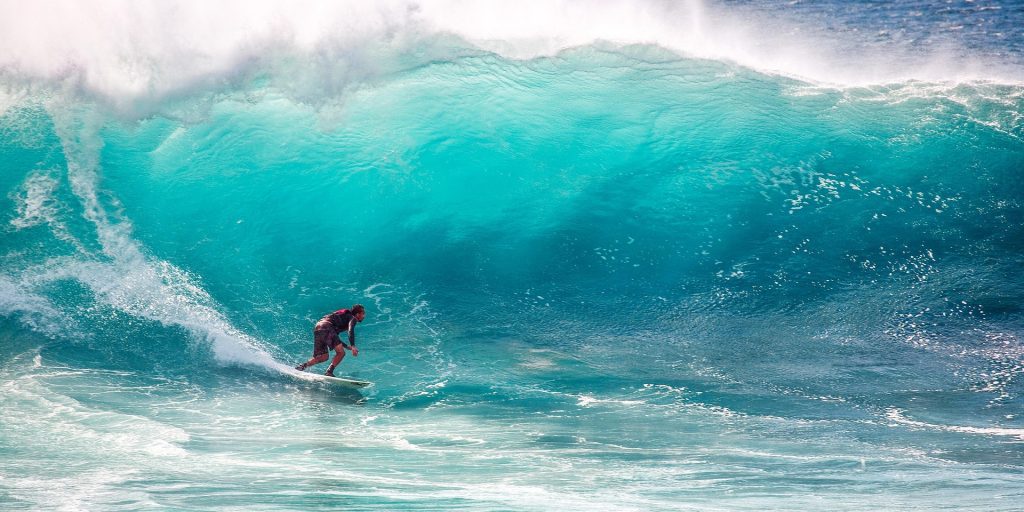 Surfer riding a big blue wave