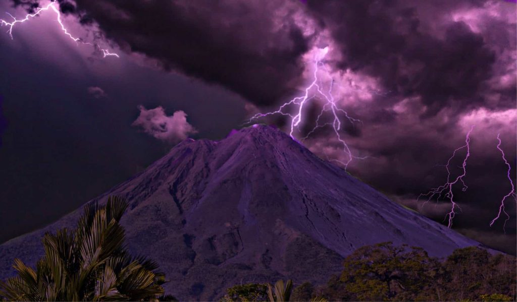 purple stormclouds and lightning over arenal volcano costa rica