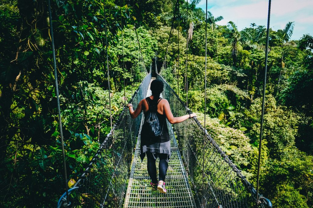 woman wearing a backpack while hiking in the jungle