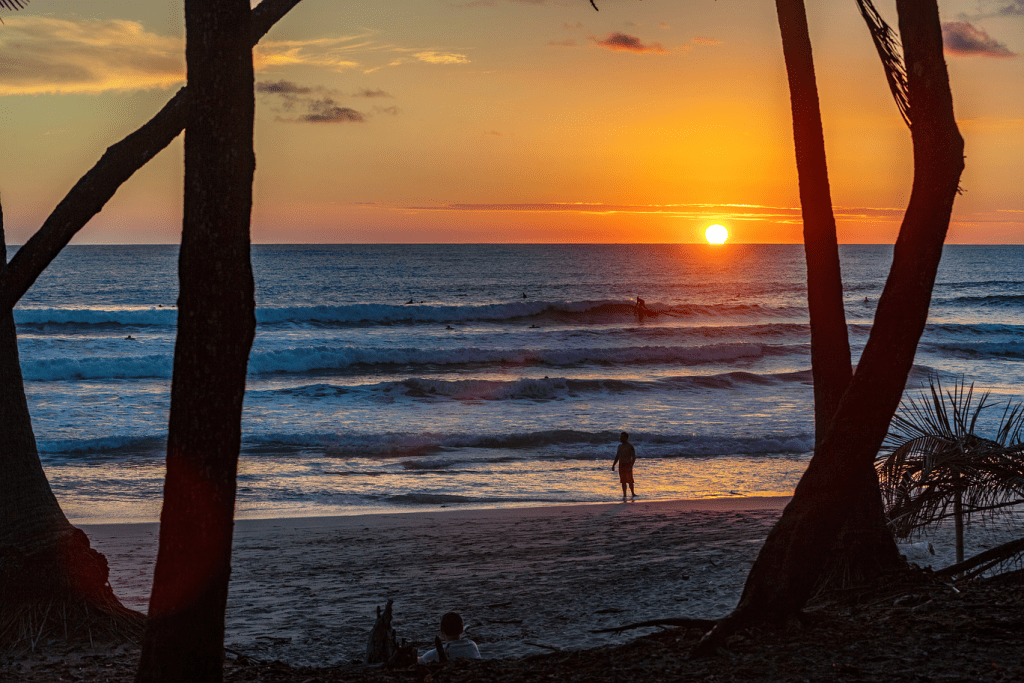 Sunset surfing and lounging on the beach in front of Casa Teresa Luxury Villas in Santa Teresa, Costa Rica