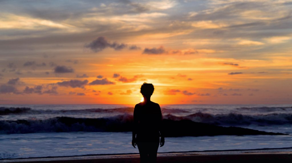 Person standing by the ocean on Santa Teresa Beach, Costa Rica