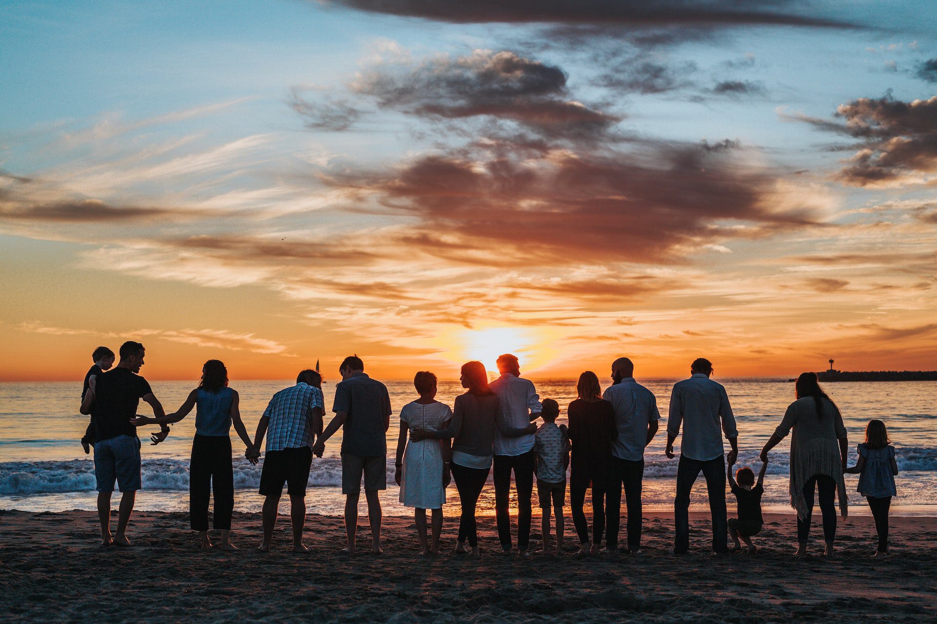 a large family enjoying their family reunion on the beach