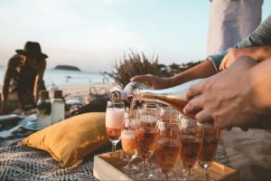 pouring champagne on beach