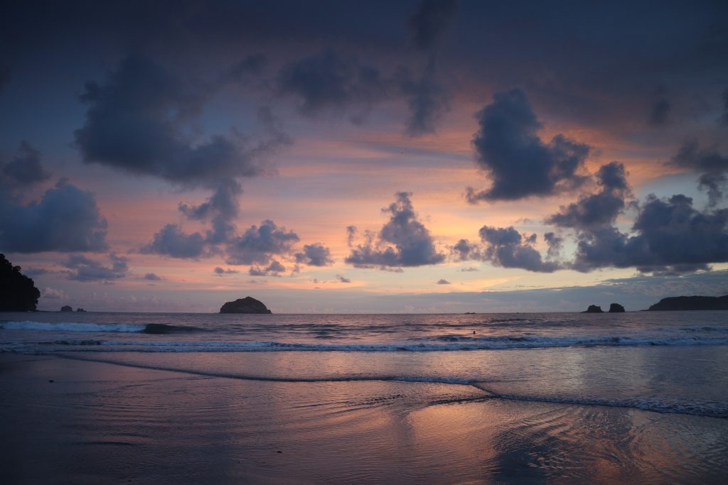 Sunset over a beach in Costa Rica with pink and orange colors