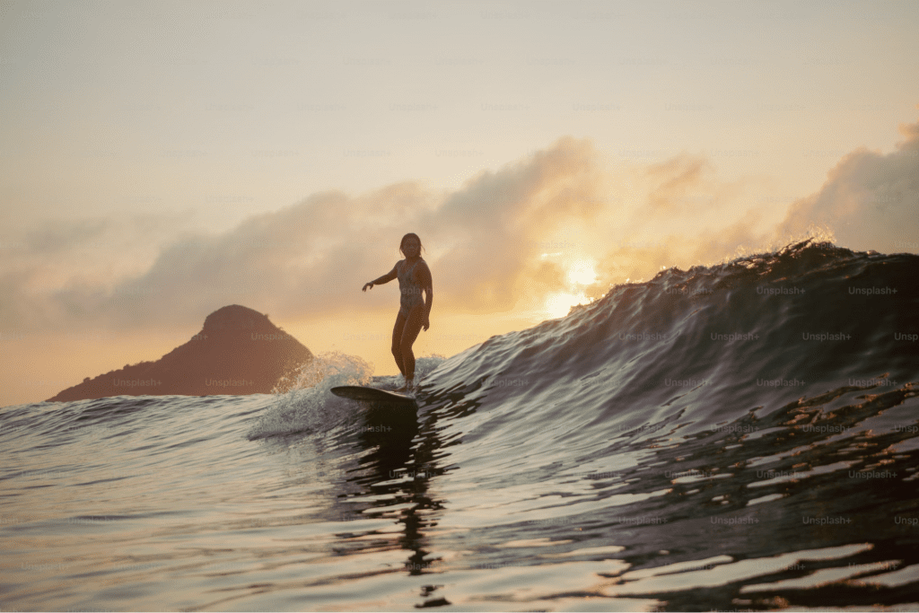 Surfer catching a wave at sunset in Costa Rica