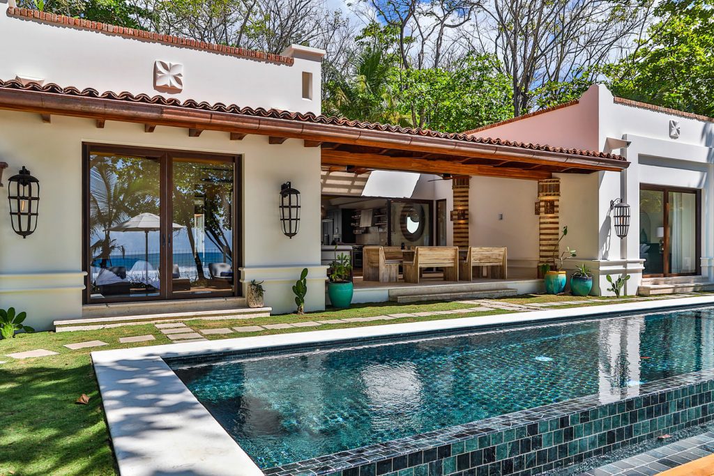 Private Villa with infinity pool and open layout patio in Santa Teresa, Costa Rica with ocean views reflecting in the bedroom doors