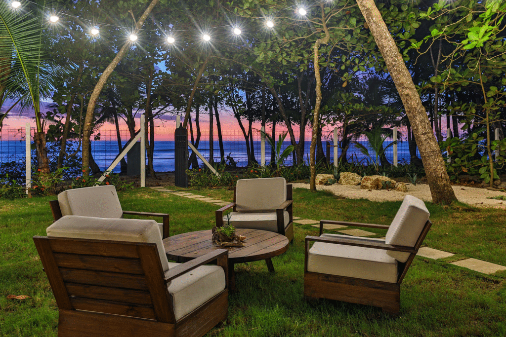 Lounge area seating outside in a lush garden at sunset in beachfront villa property Casa Teresa, Costa Rica