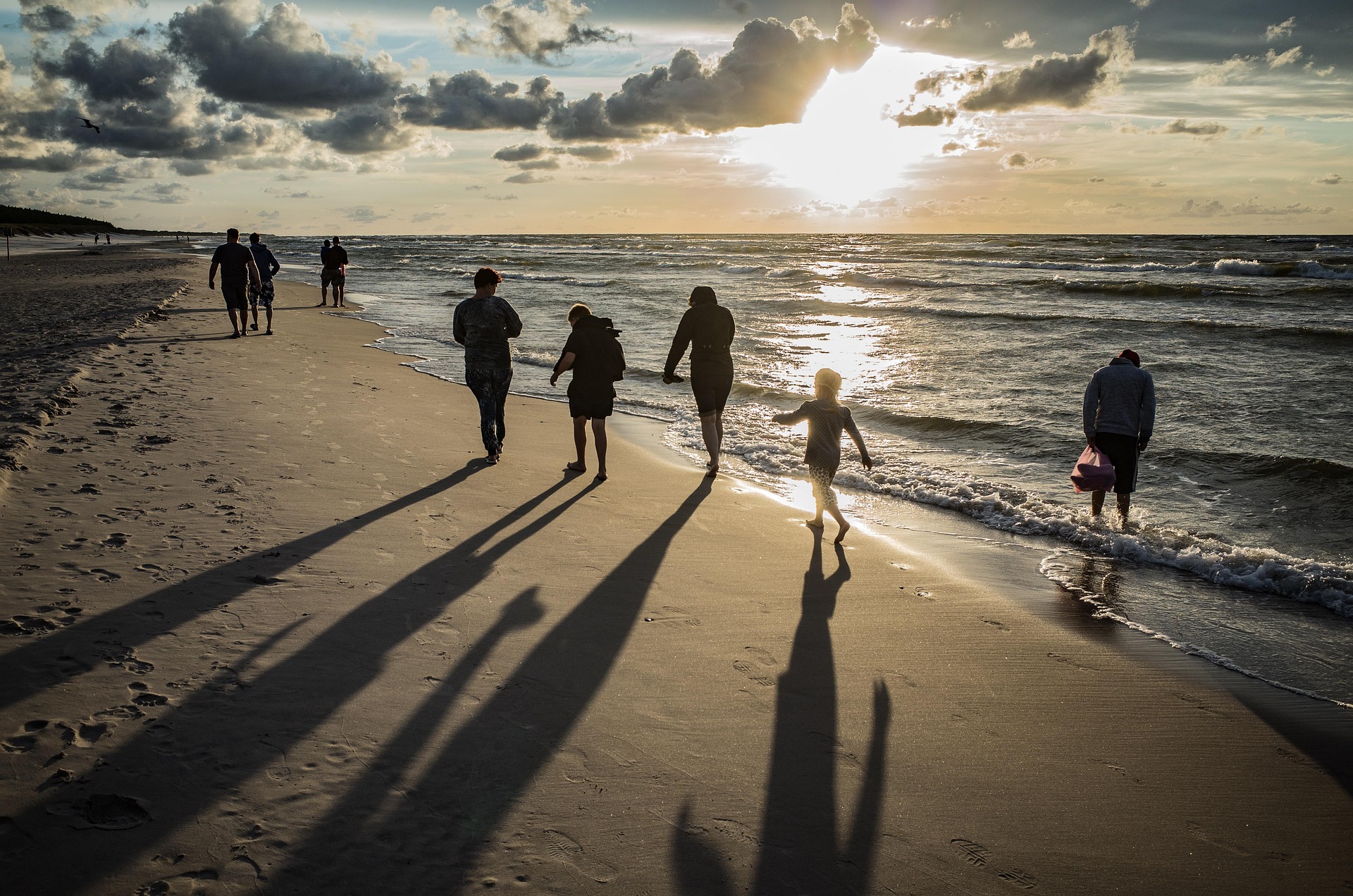 A multigenerational family walking along a Costa Rican beach in late afternoon